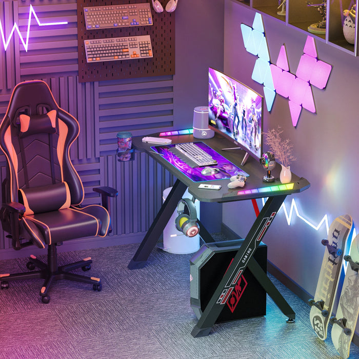 100x60x78cm Gaming Desk with Dynamic RGB LED Lights, Black, Sturdy Metal Legs, 3D Carbon Fibre Surface, Large Size, Stable Design for PC Setup