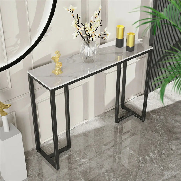 Minimalist console table with dark marble top and sleek black metal legs
