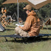 Portable black camp bed with folding structure and dedicated storage bag